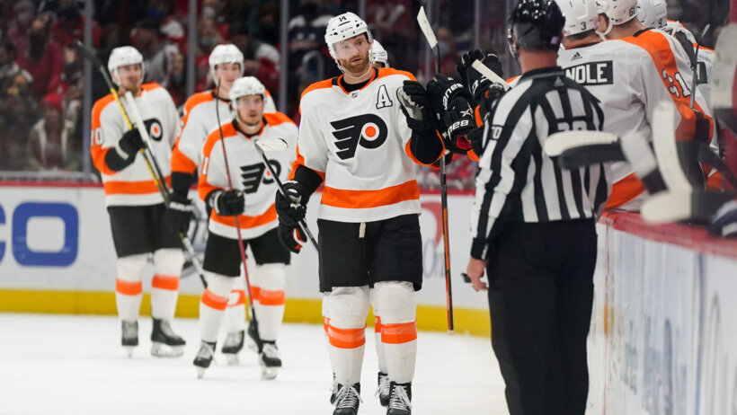 Sean Couturier skating by bench