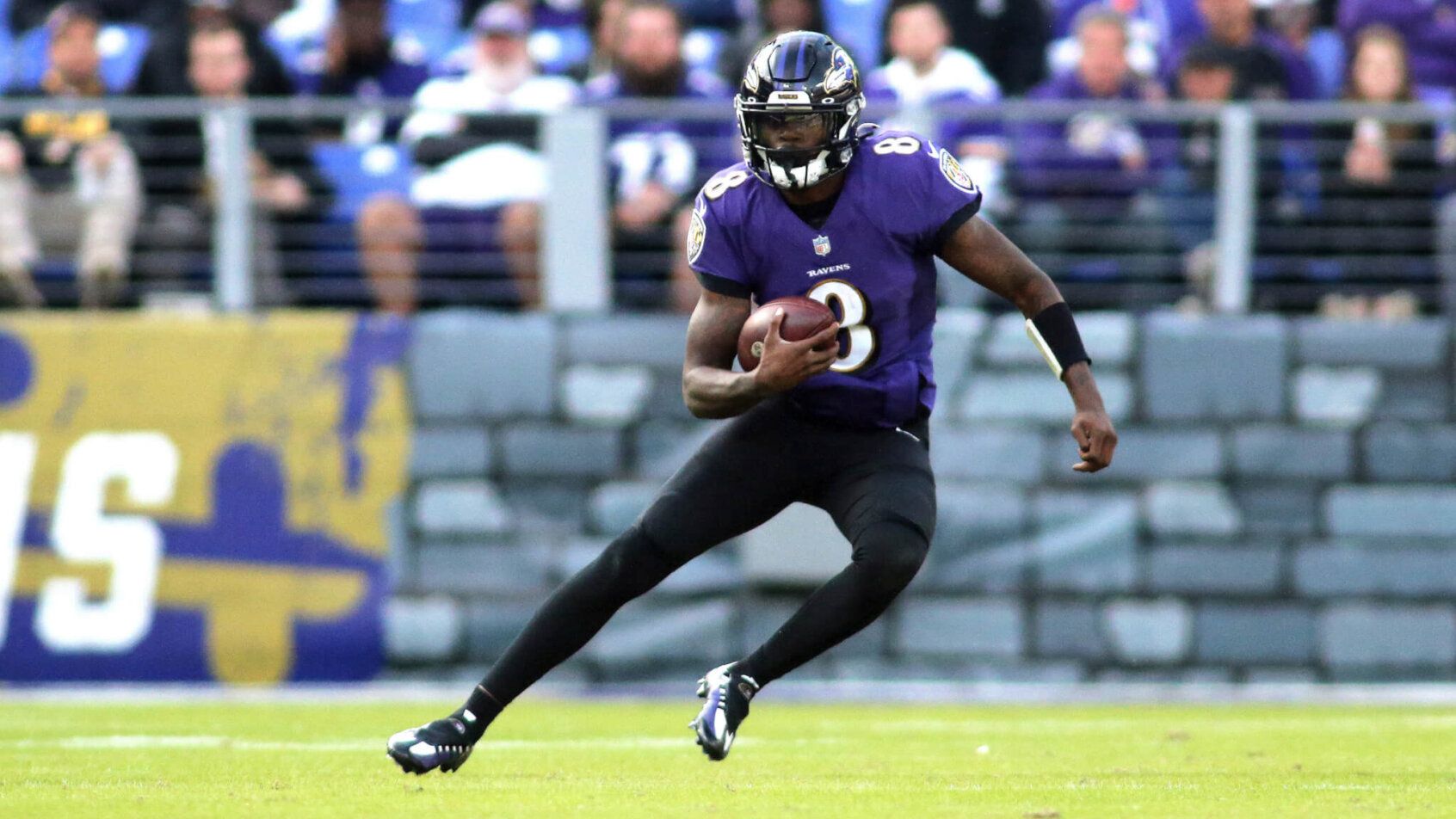 Lamar Jackson carries the ball against the Vikings