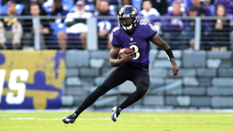 Lamar Jackson carries the ball against the Vikings