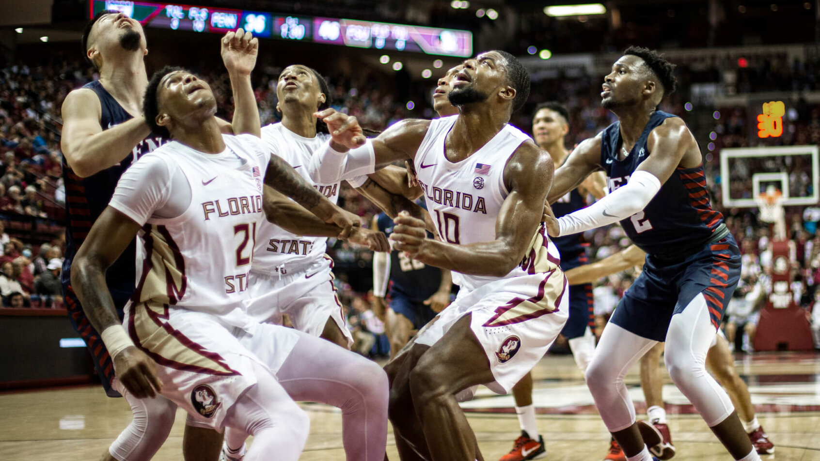 Players under hoop waiting for rebound