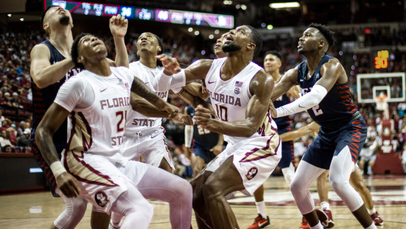 Players under hoop waiting for rebound