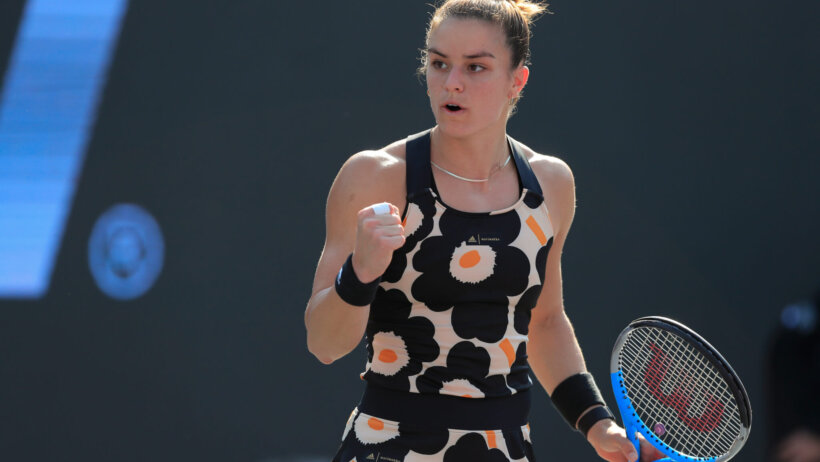 Maria Sakkari reacting with a fist bump after winning a point during a tennis match.