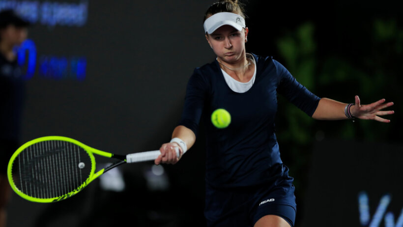 Barbora Krejcikova hitting a return shot during a tennis match.