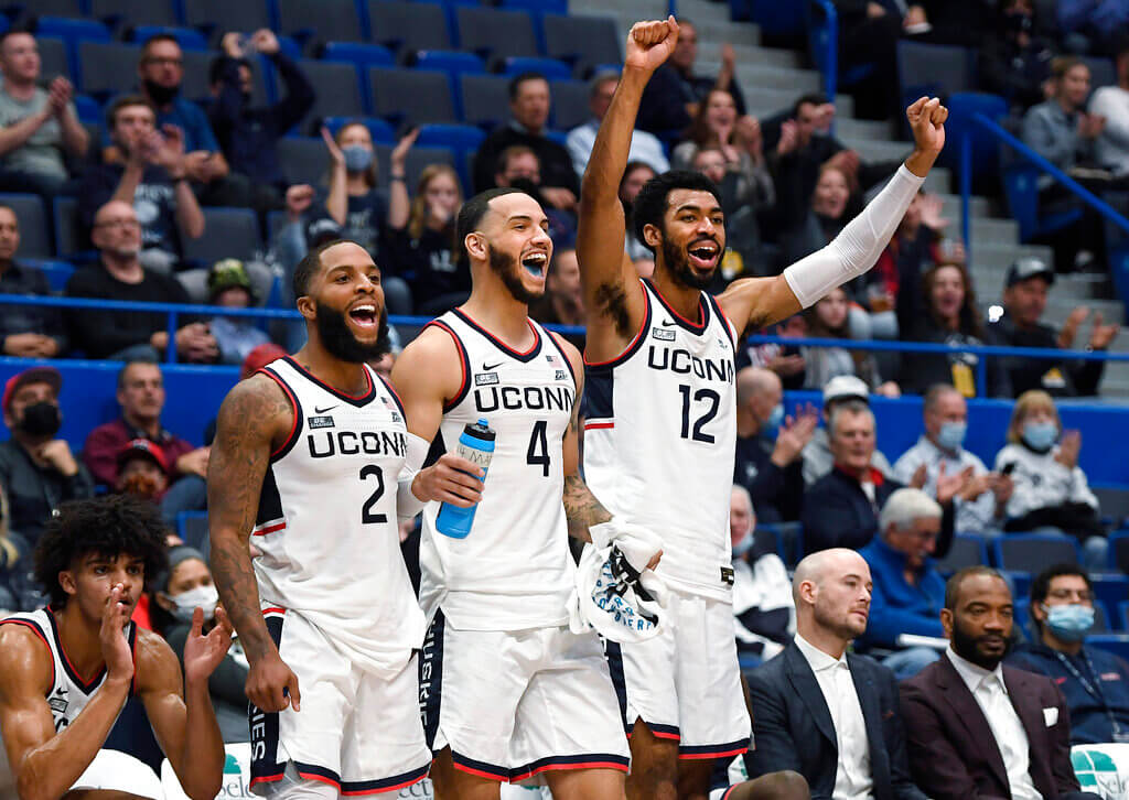 Connecticut's R.J. Cole (2), Tyrese Martin (4) and Tyler Polley (12)