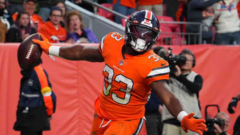 Denver Broncos running back Javonte Williams running the ball during an NFL game.