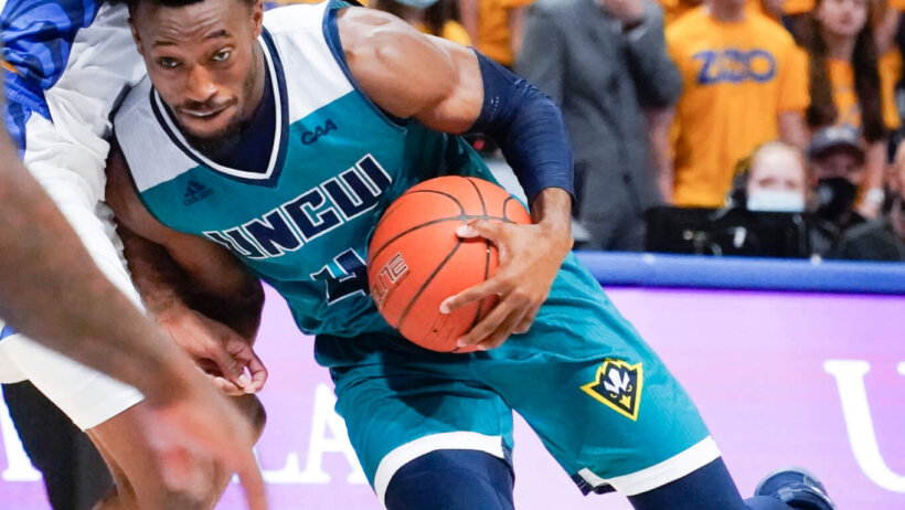 UNC Wilmington's Mike Okauru driving past a defender