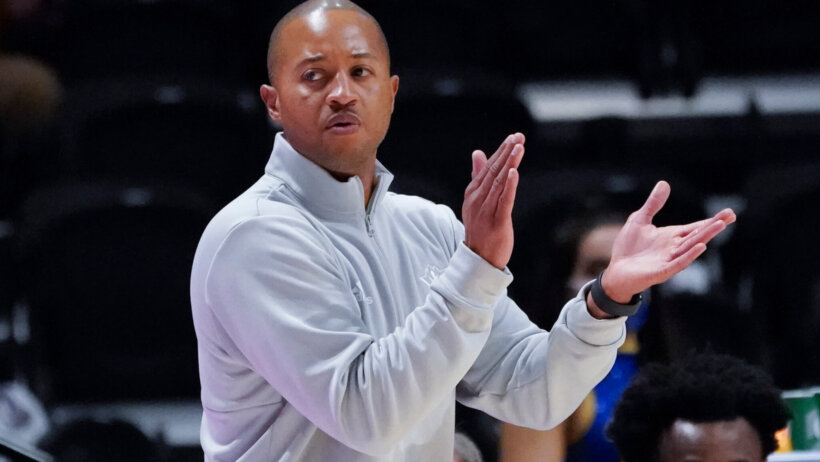 UNC Wilmington head coach Takayo Siddle clapping on the sideline