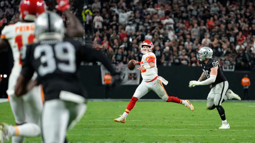 Kansas City Chiefs quarterback Patrick Mahomes looking to pass the ball during an NFL game.