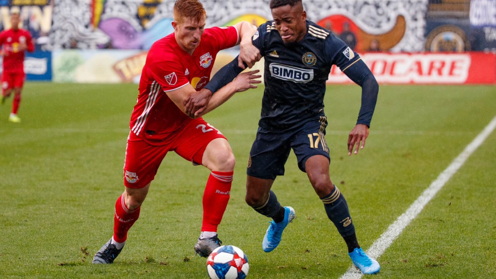 Philadelphia Union and New York Red Bulls player battle for ball
