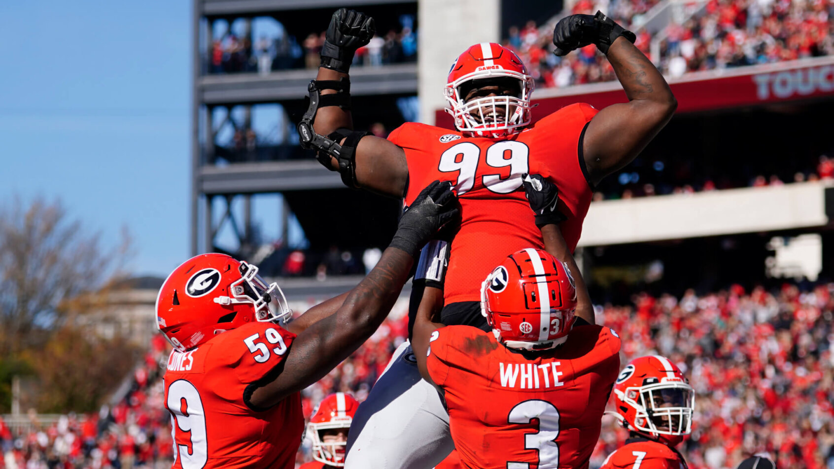 Georgia defensive lineman Jordan Davis being lifted into the air by teammates.