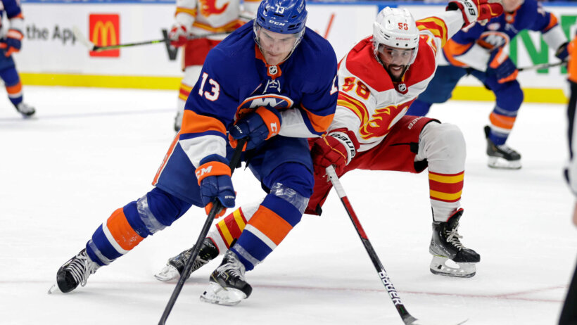 Mathew Barzal with puck shielding defender