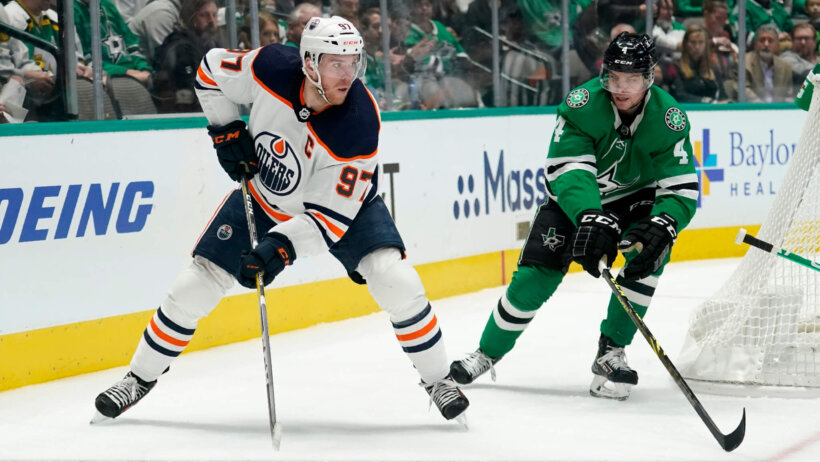 Connor McDavid looking to pass behind the net