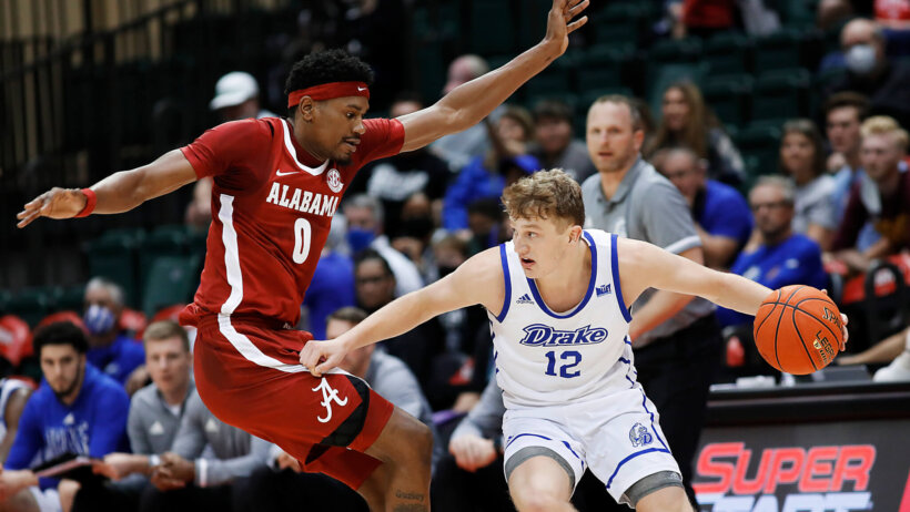 Drake guard Tucker Devries dribbling against defender