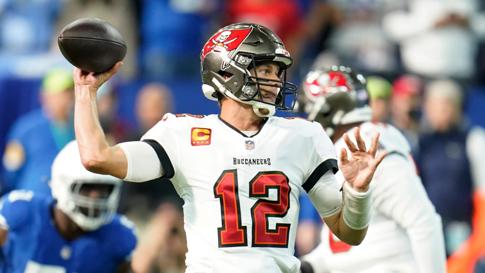 Tampa Bay Buccaneers quarterback Tom Brady looking to throw the ball during a football game.