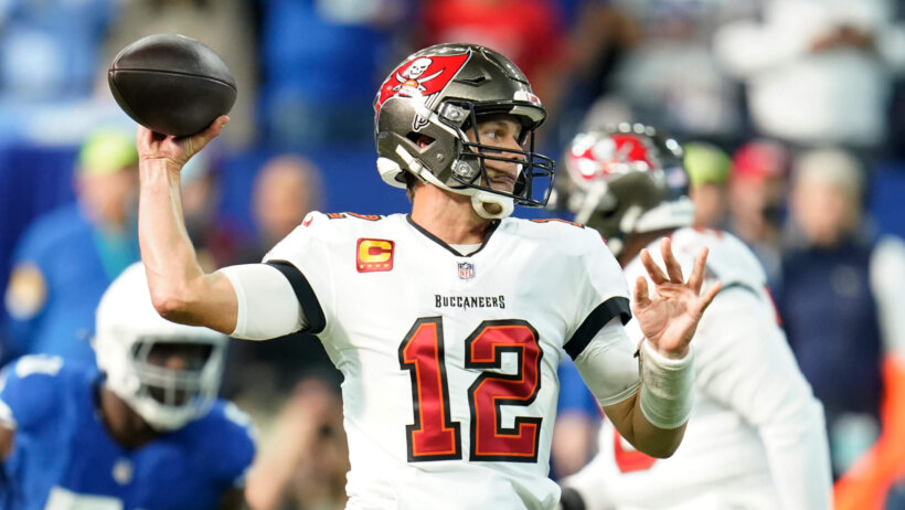 Tampa Bay Buccaneers quarterback Tom Brady looking to throw the ball during a football game.