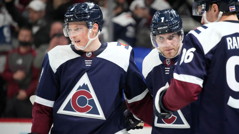 Colorado Avalanche players on the ice during an NHL game.