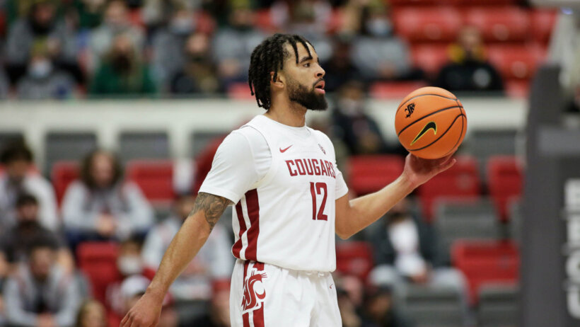 Michael Flowers brings the ball up court