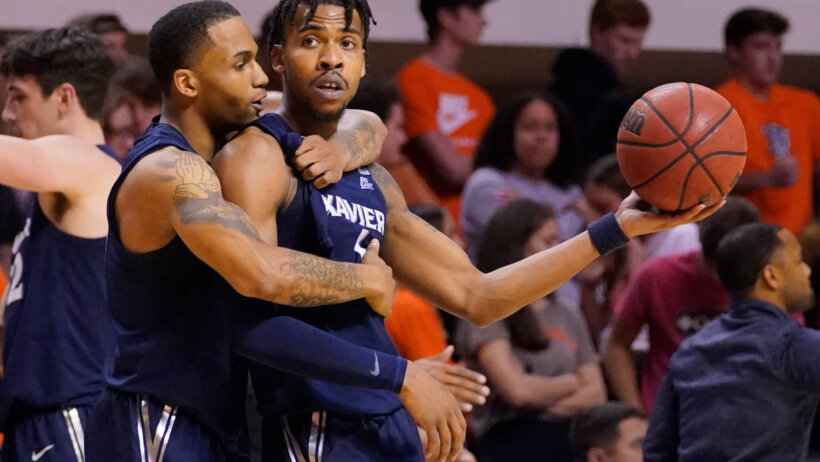 Xavier guard Dwon Odom celebrating with Paul Scruggs