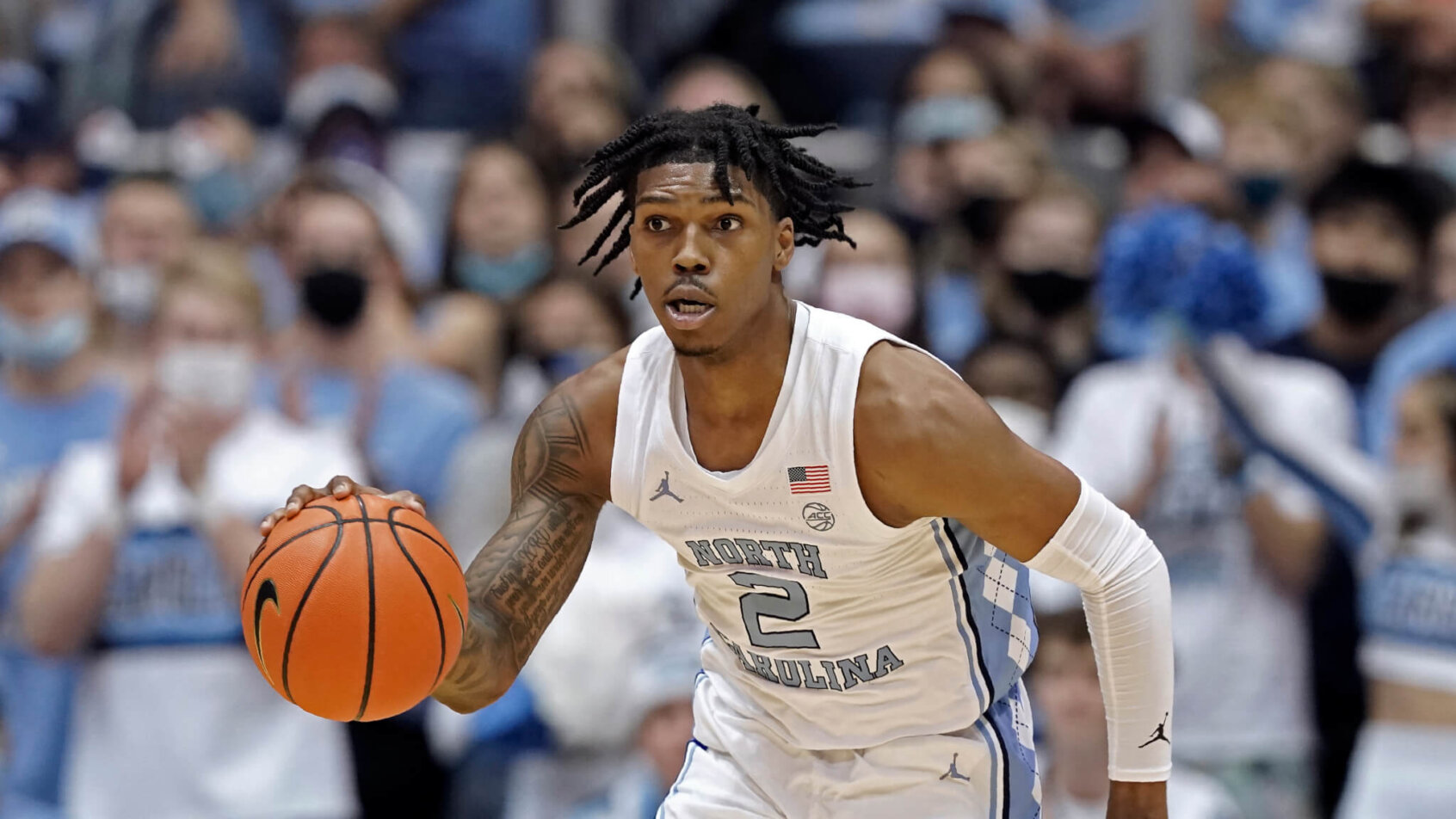 North Carolina guard Caleb Love dribbles up the court