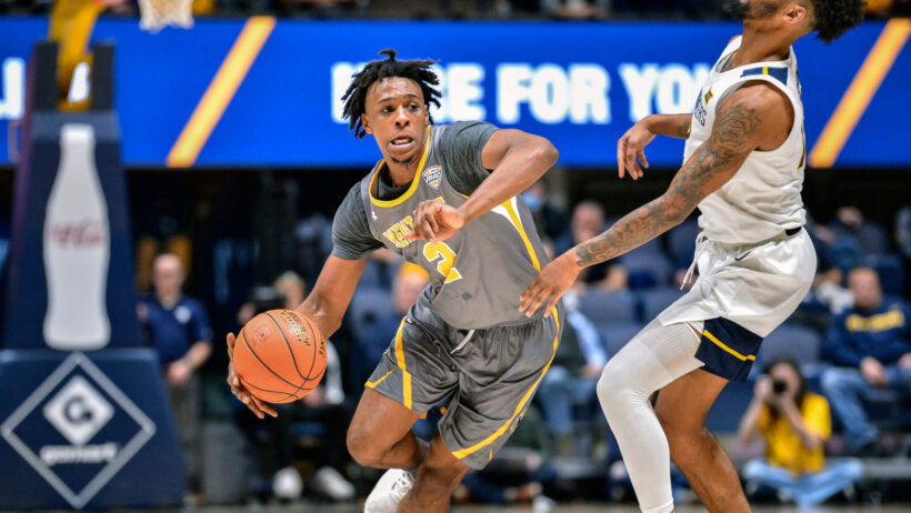 Kent State guard Malique Jacobs dribbling past a defender