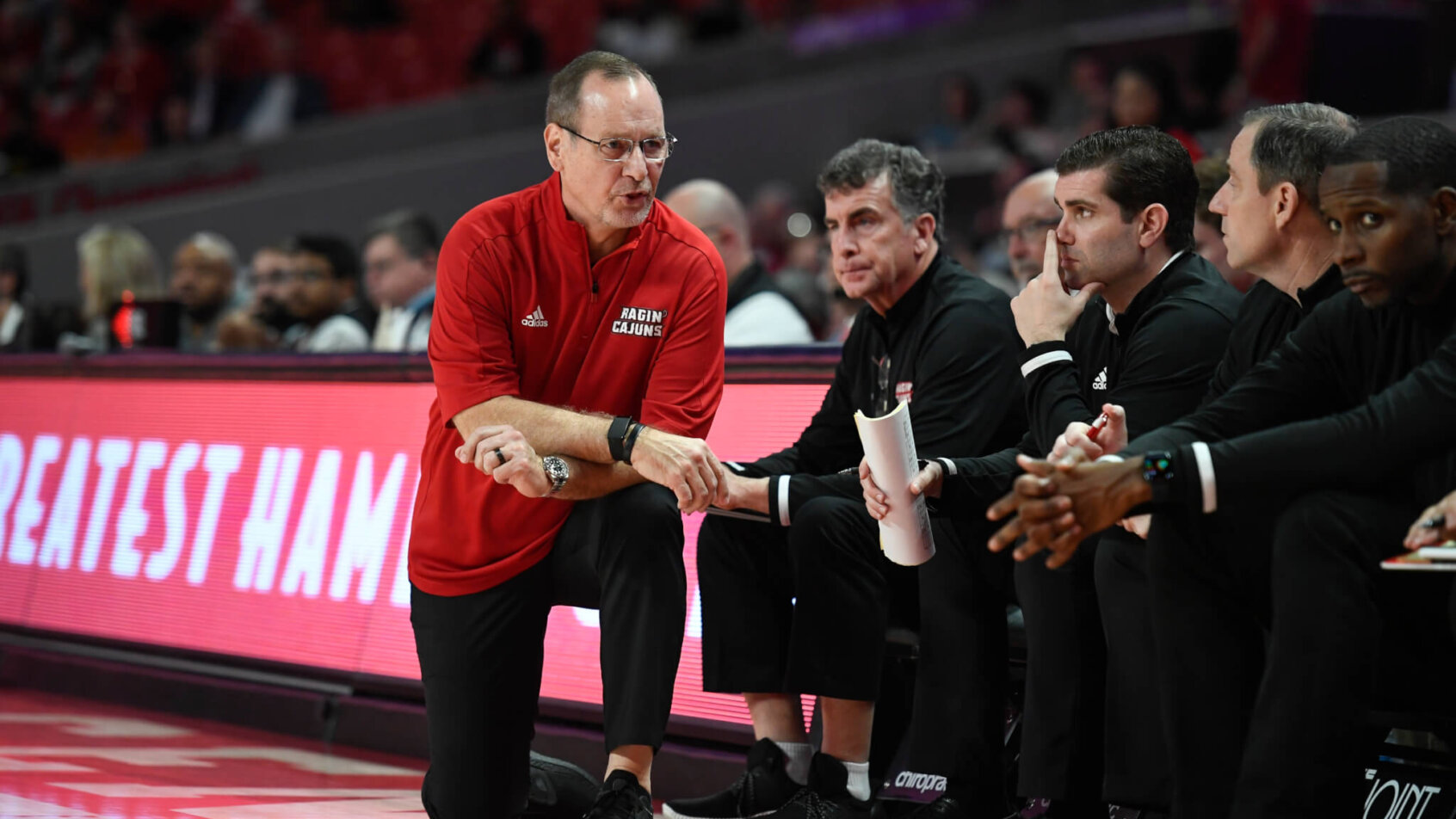 Bob Marlin converses with his staff