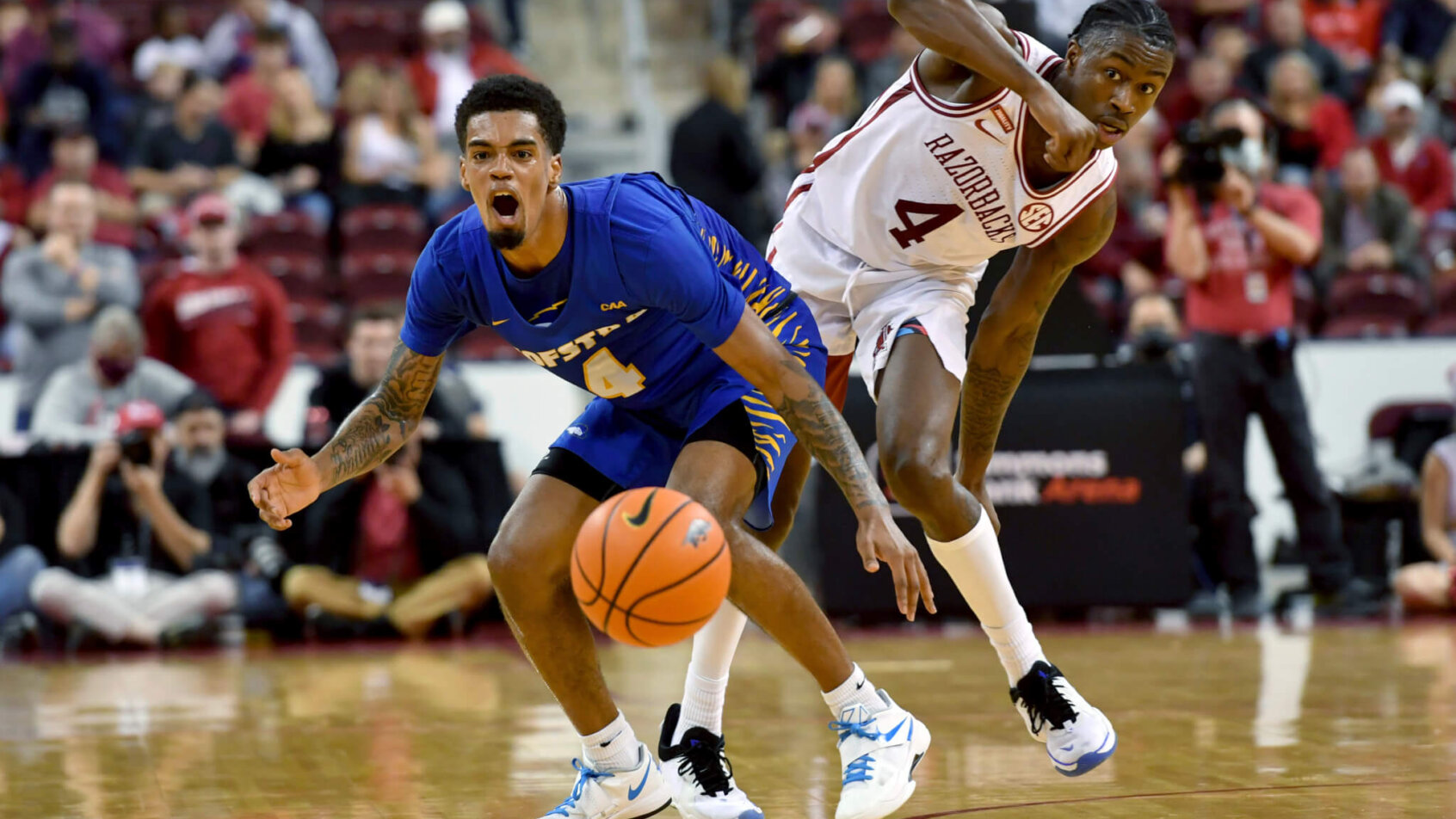 Hofstra guard Aaron Estrada reacting after getting fouled by an Arkansas defender
