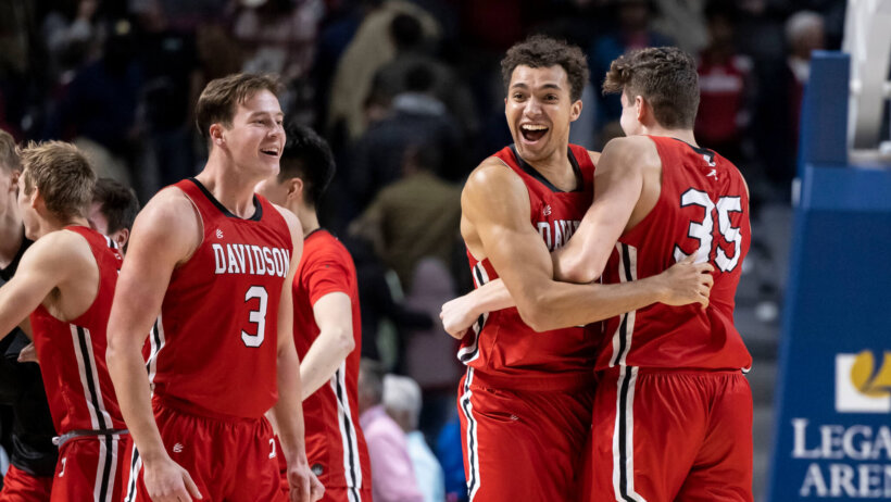 Davidson forward Nelson Boachie-Yiadom hugging teammate Luka Brajkovic