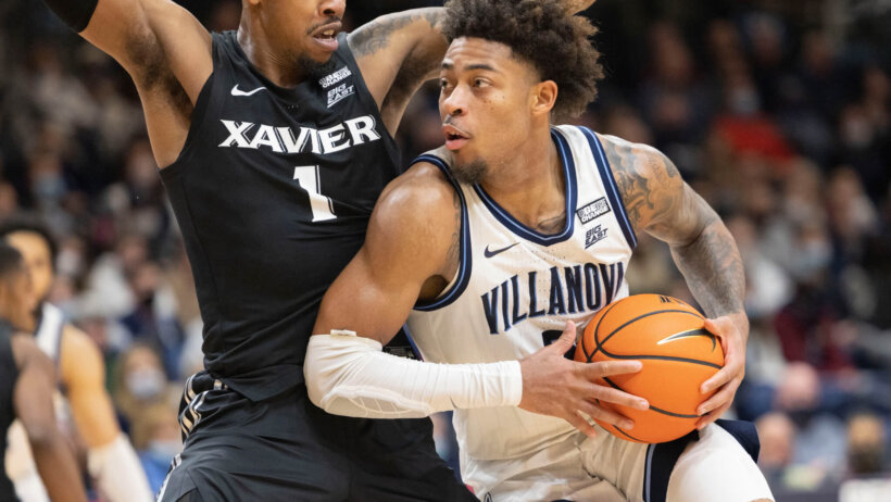 Villanova guard Justin Moore leaning into a defender