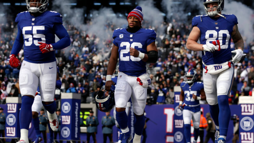 The Giants run onto the field