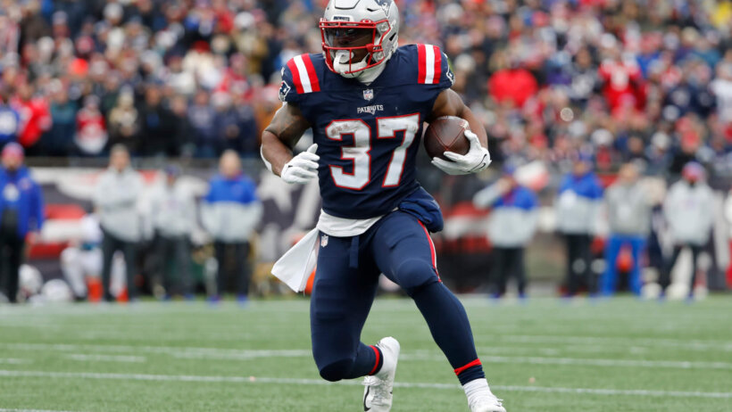 Damien Harris running with football