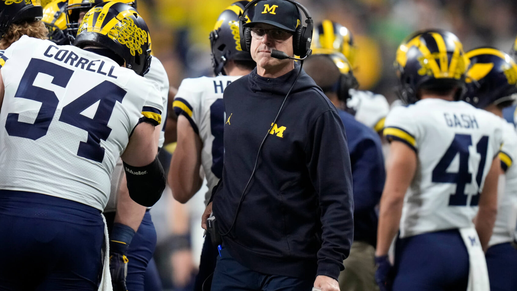 Jim Harbaugh looks around