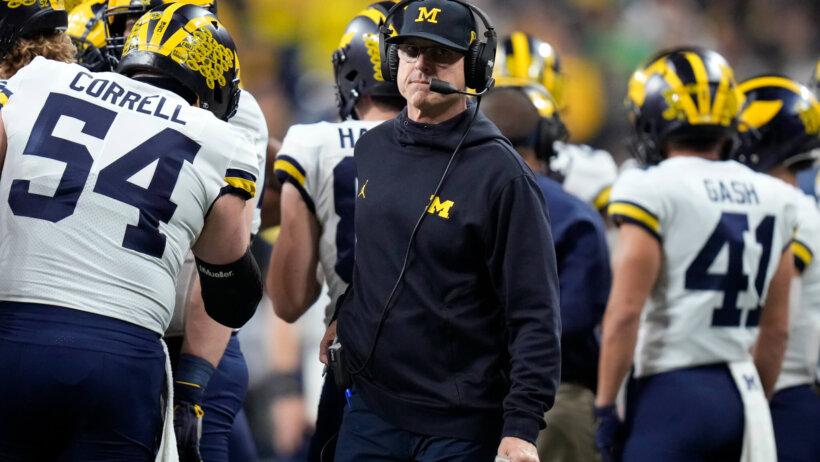 Jim Harbaugh looks around
