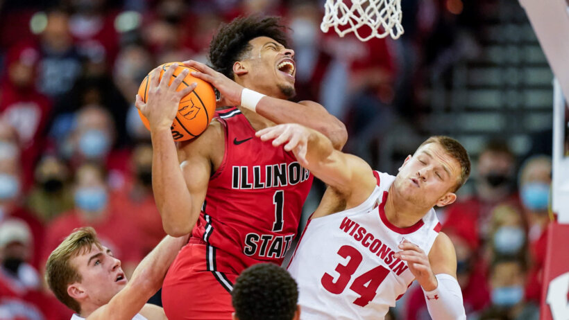 Wisconsin player Brad Davison fouls Sy Chatman of Illinois State during a NCAA basketball game.