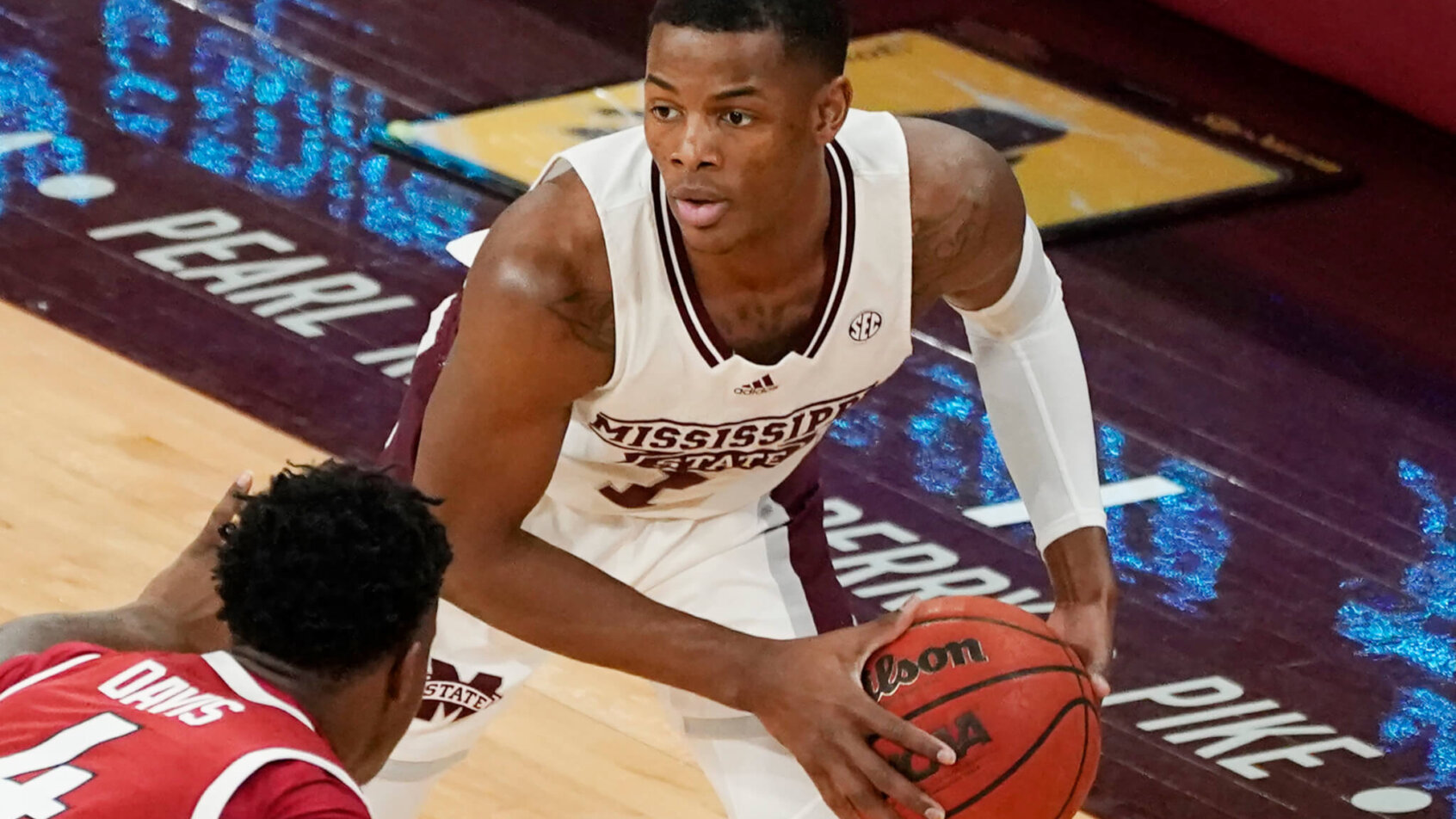 Mississippi State guard Iverson Molinar shielding the ball from an Arkansas defender