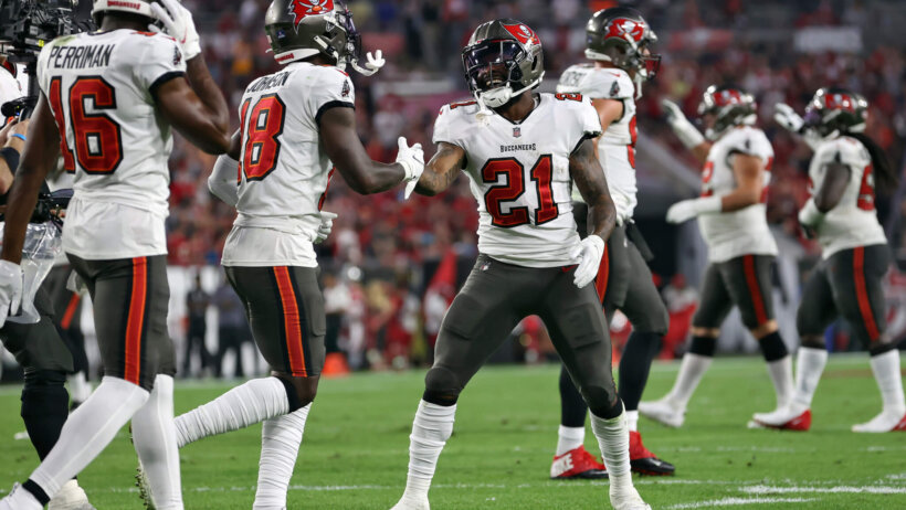 Tampa Bay Buccaneers players celebrating on the field.