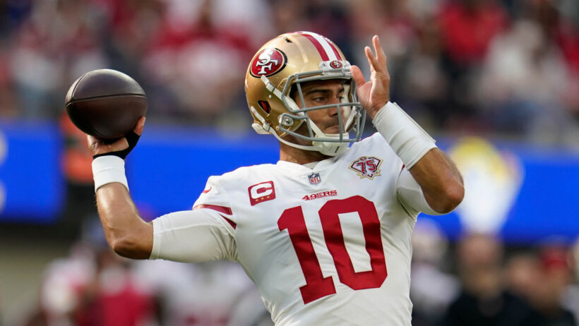 Jimmy Garoppolo throwing a football during an NFL game.