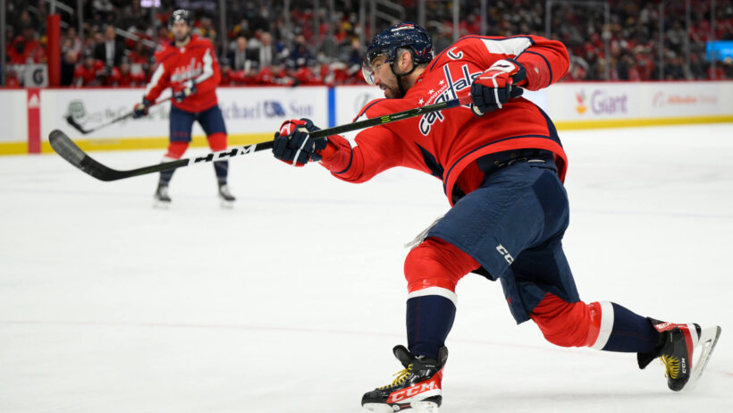 Alexander Ovechkin following through on a shot during an NHL hockey game.