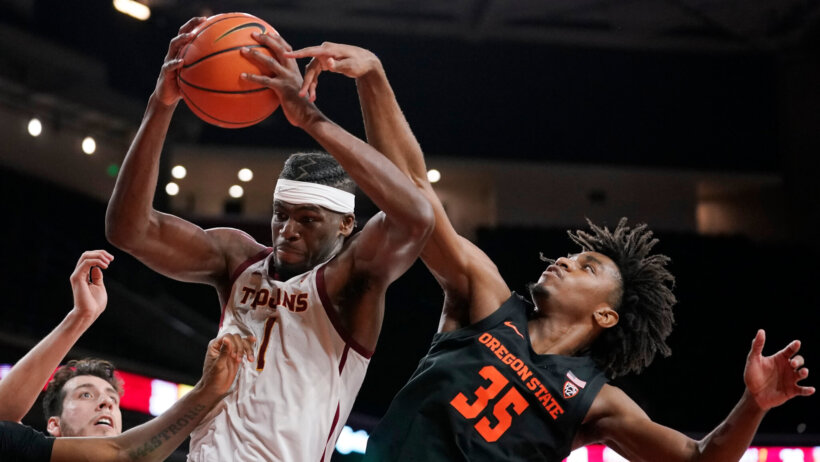 Tw players fighting for rebound under the basket