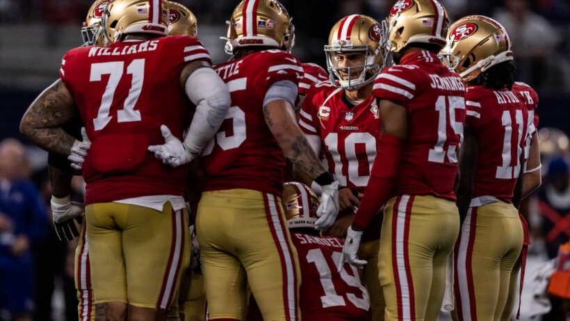 San Francisco 49ers quarterback Jimmy Garoppolo huddling around his teammates.