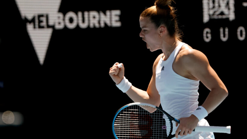 Maria Sakkari reacting with a fist pump after winning a point during a tennis match.