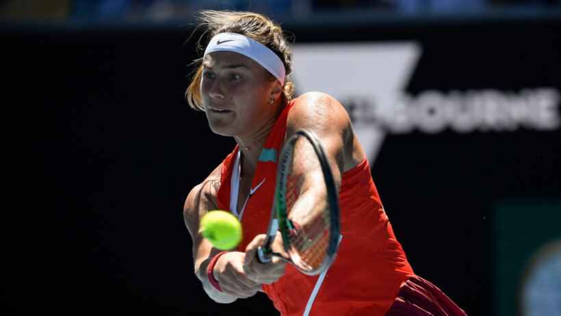Aryna Sabalenka hitting a backhand return during a tennis match at the Australian Open.
