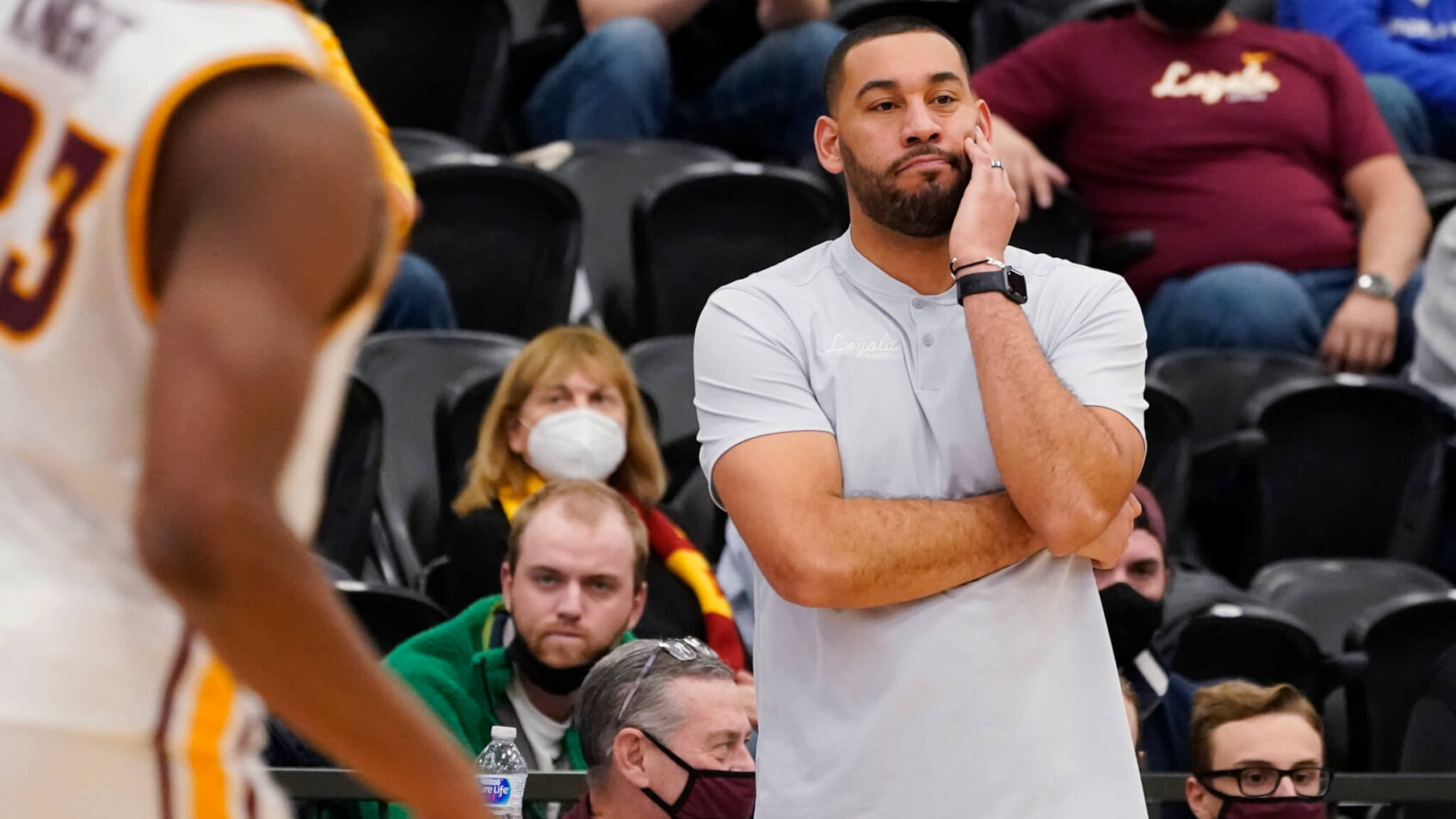 Loyola Chicago head coach Drew Valentine watching his team