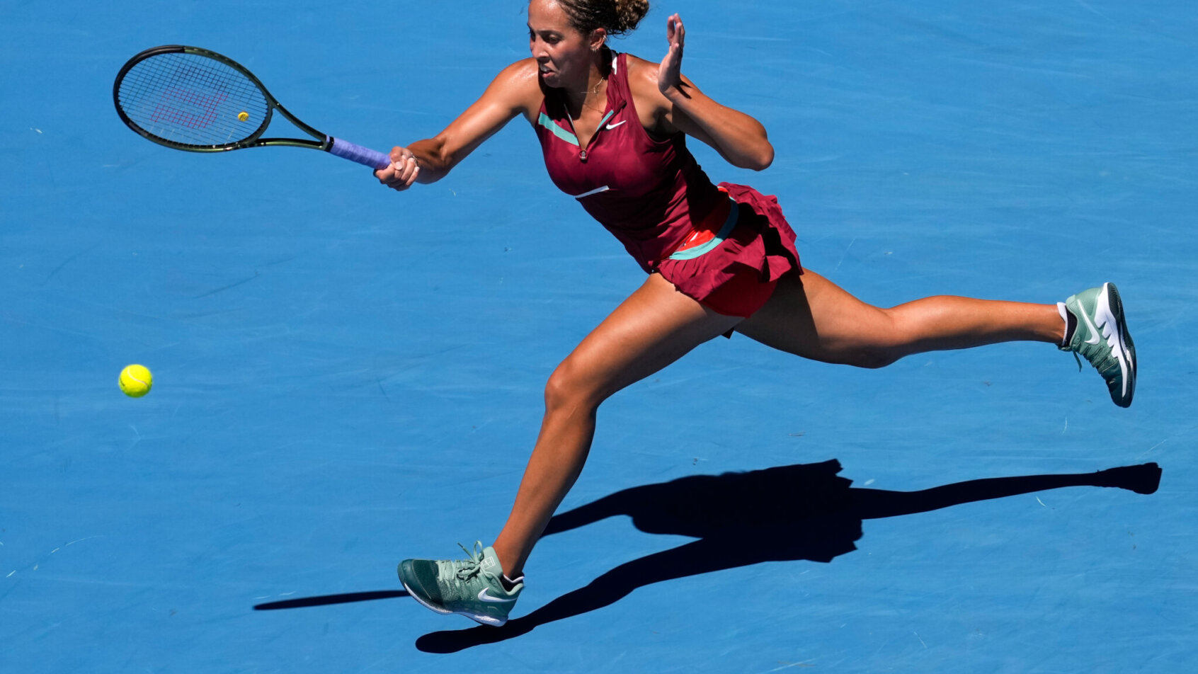 Madison Keys stretching for a forehand during a match at the Australian Open.
