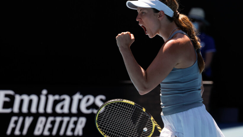 Danielle Collins reacting with a fist pump and a yell after winning a point during a tennis match at the Australian Open.