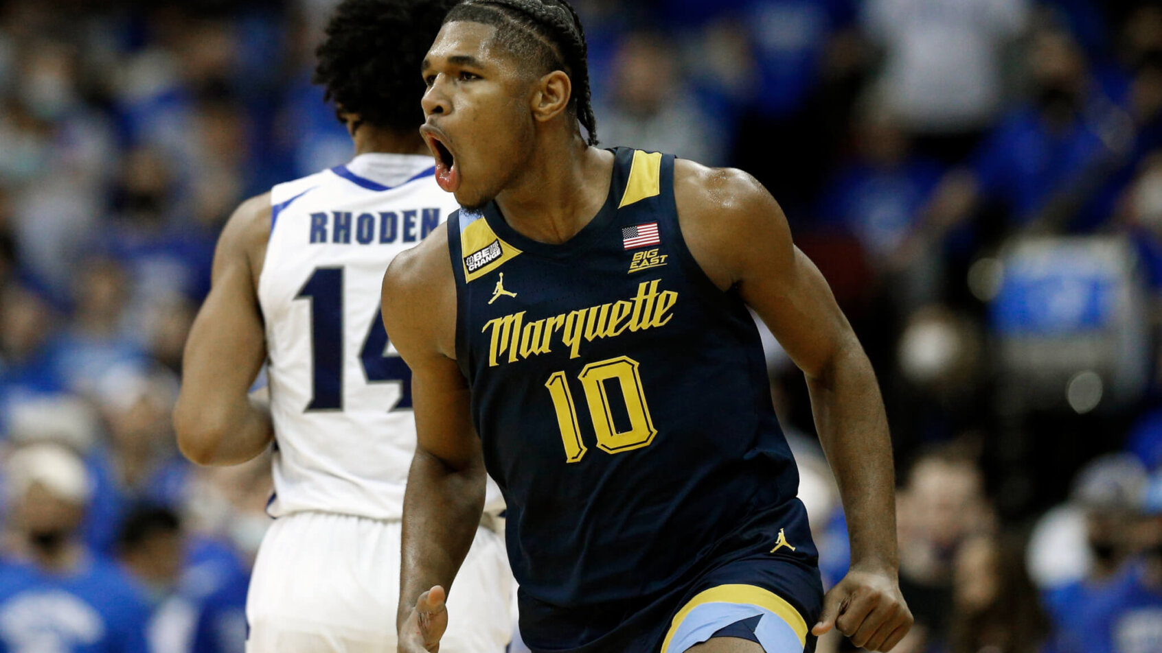 Marquette forward Justin Lewis celebrates after making a three