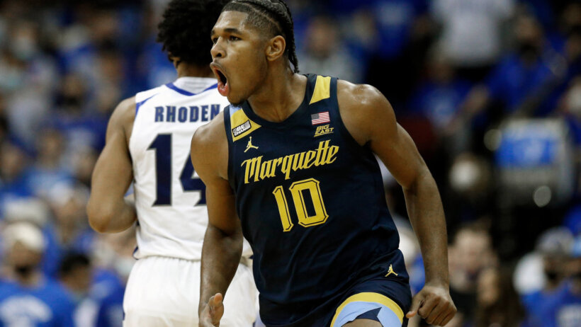 Marquette forward Justin Lewis celebrates after making a three