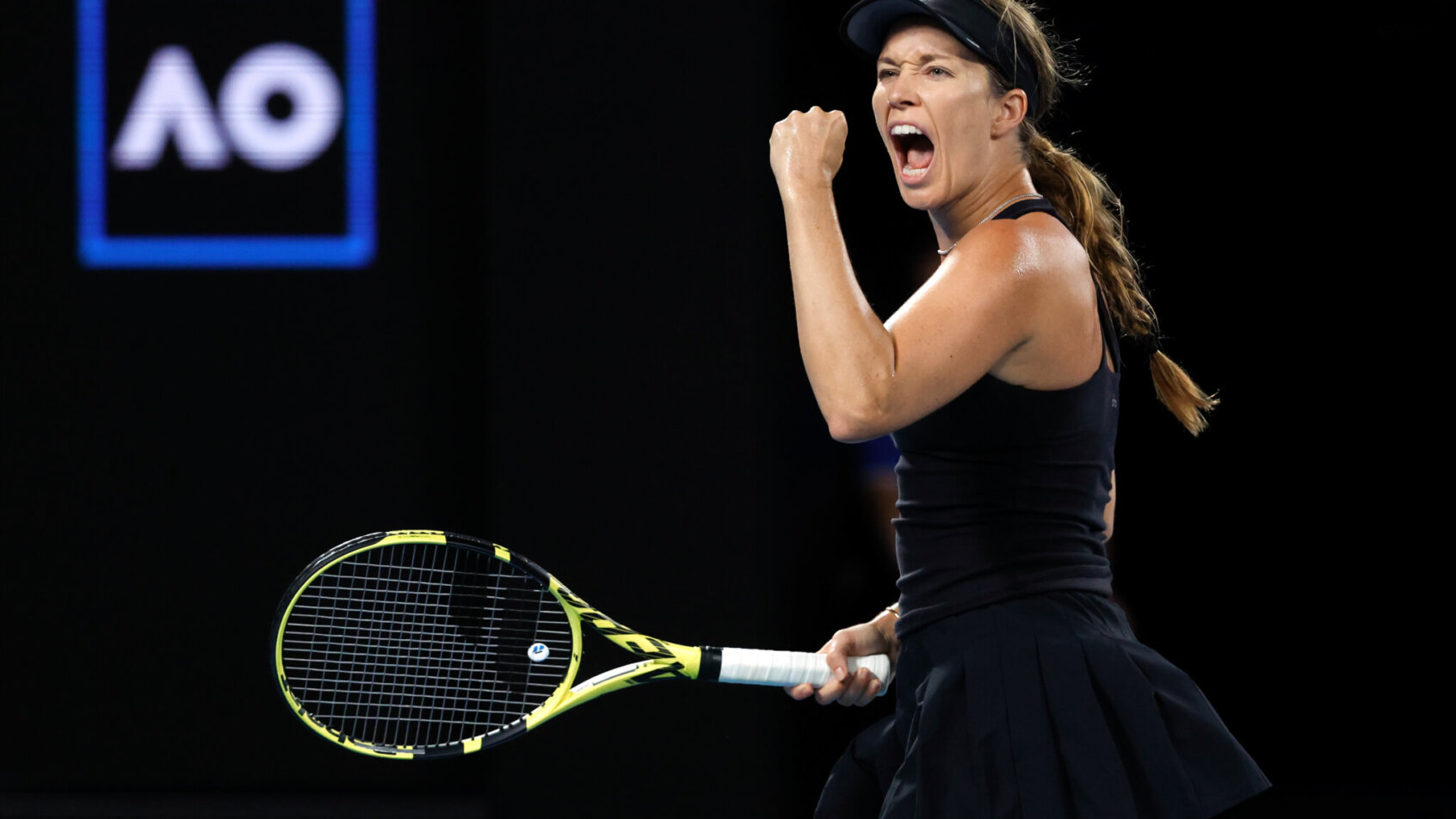 Danielle Collins reacting with a yell and fist pump after winning a point during a match at the 2022 Australian Open.