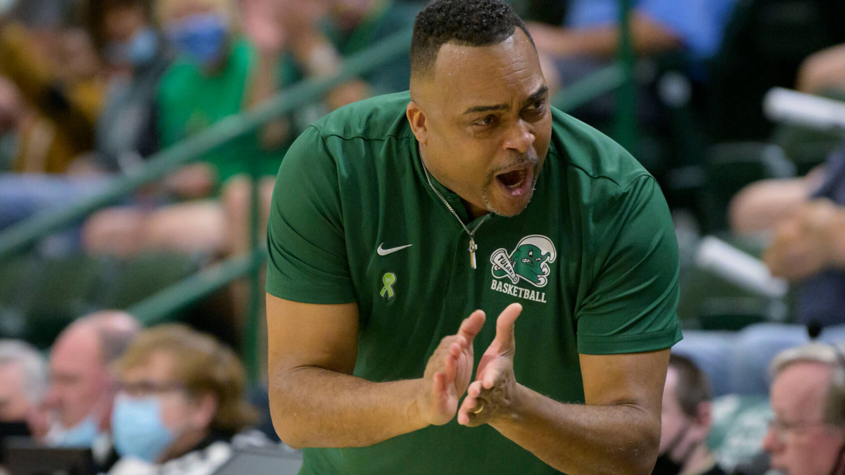 Tulane coach Ron Hunter cheering on his team