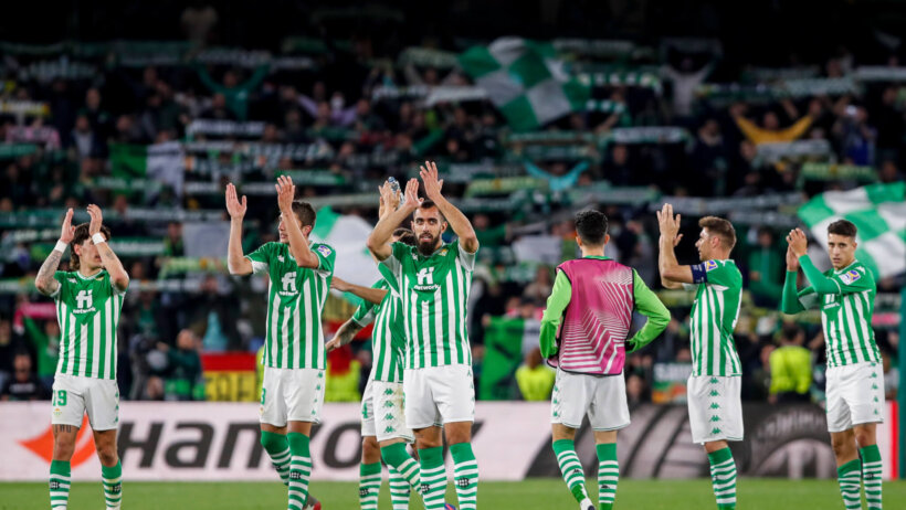 Betis players applaud to the crowd after the end of a game.