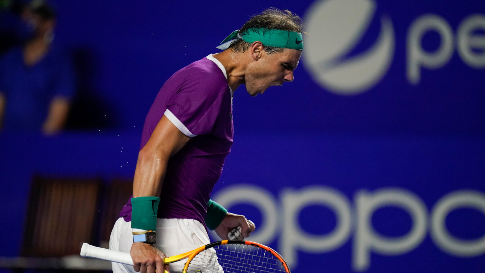 Rafael Nadal celebrating winning a point during a tennis match.